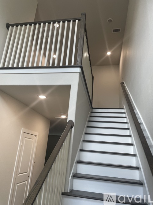 A staircase with a metal railing and wooden steps.