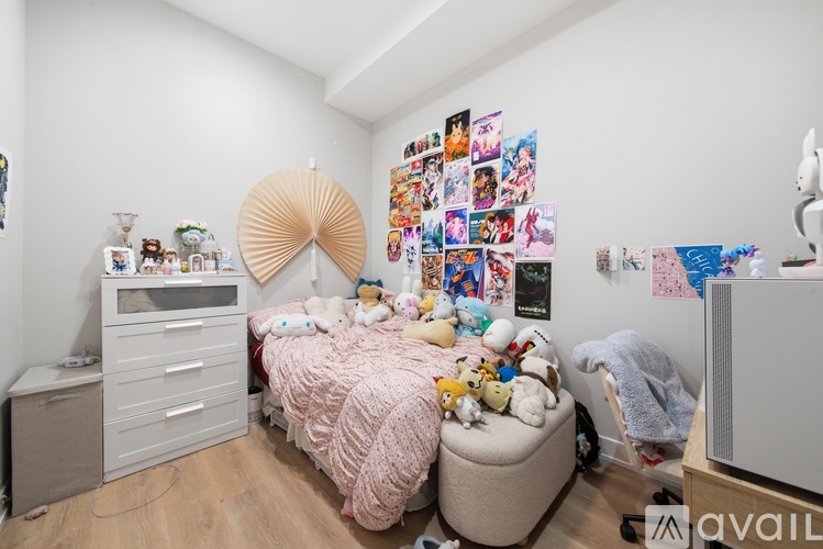 A child's bedroom with a bed, dresser, and a wall covered in posters.