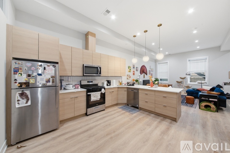A modern kitchen with wooden cabinets and stainless steel appliances.