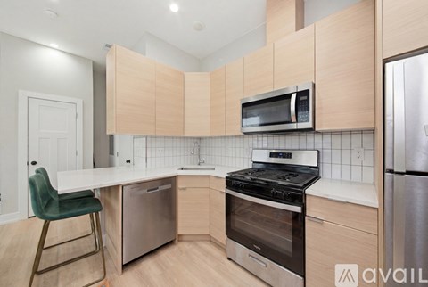 A kitchen with a stove top oven and a microwave above it.