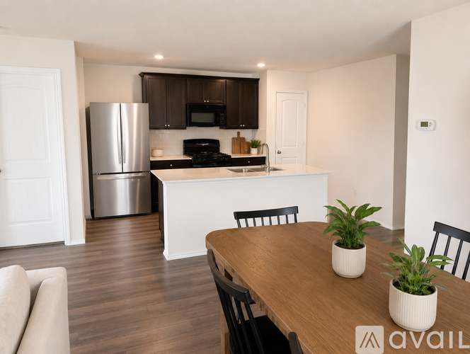 A modern kitchen with a wooden table and chairs.