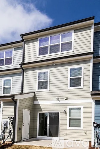 A two-story house with a grey and white exterior.