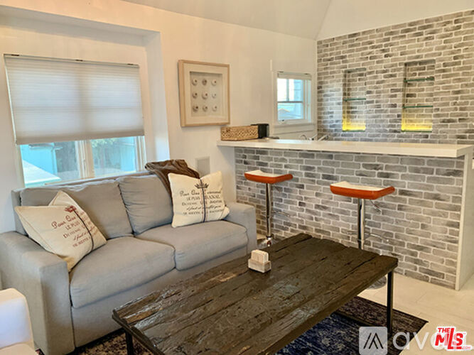 A living room with a grey couch and a wooden coffee table.