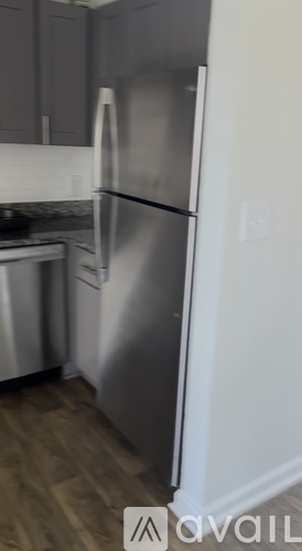 A stainless steel refrigerator in a kitchen.