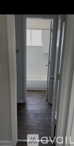 A hallway with a door at the end.