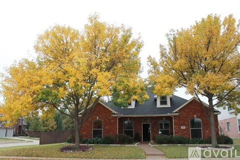 A house with a tree in front of it.