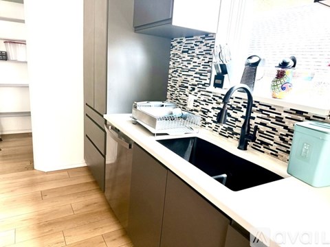 A kitchen with a sink and a counter.