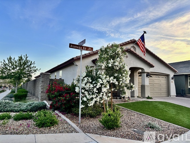 A house with a sign that says Alameda in front of it.