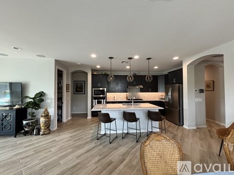 A modern kitchen with a dining table and chairs.