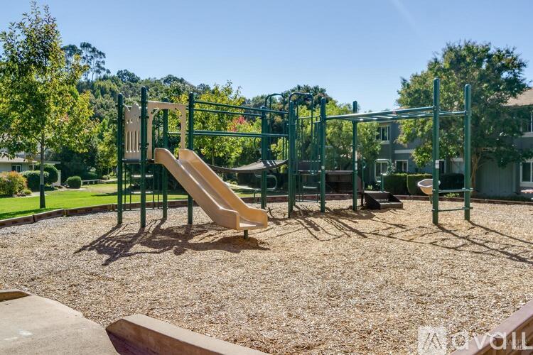 A playground with a slide and monkey bars.