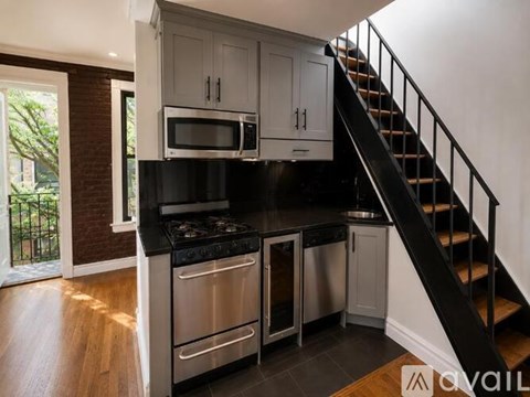 A kitchen with a stainless steel oven and microwave.