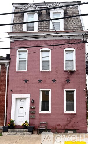 A red building with a white door and windows.