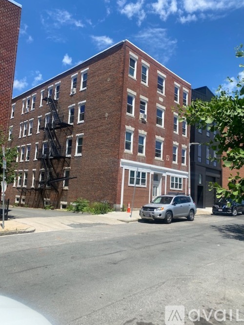 A red brick building with a fire escape on the side.