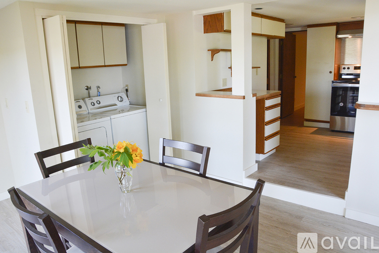 A kitchen with a table and chairs in the foreground.