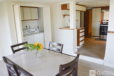 A kitchen with a table and chairs in the foreground.