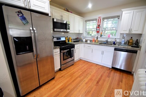 A kitchen with wooden floors and stainless steel appliances.