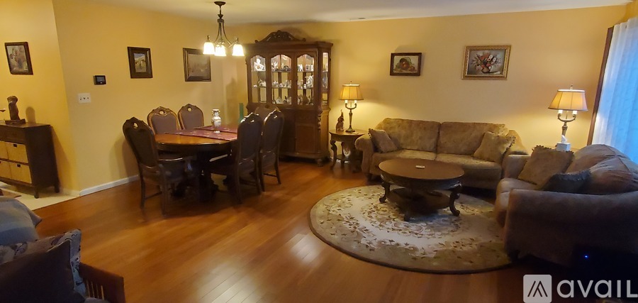 A living room with a wooden floor and furniture.