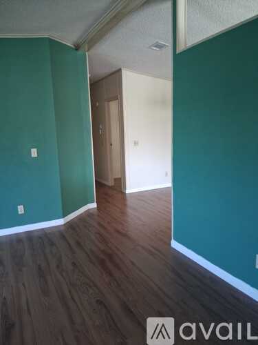A room with a wooden floor and a door.