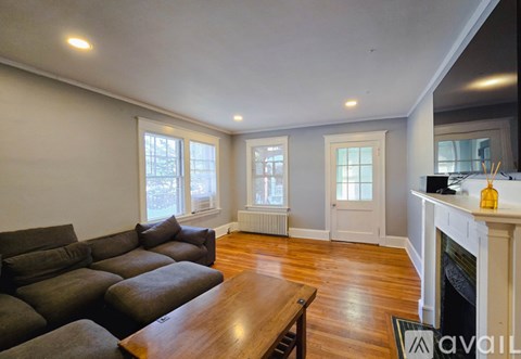 A living room with a grey couch and a wooden table.