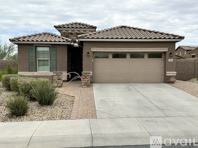 A house with a brown roof and a garage door.