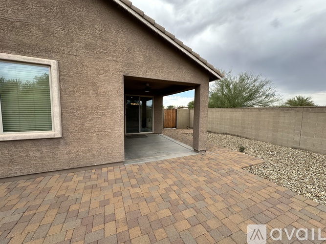 A house with a brick patio and a covered entrance.