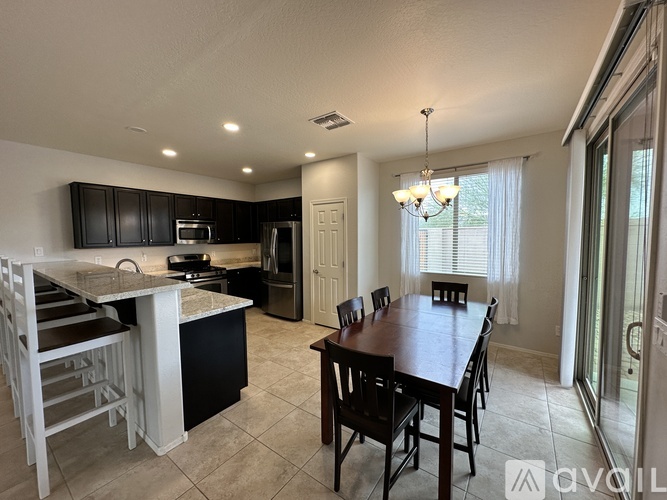 A modern kitchen with a dining table and chairs.