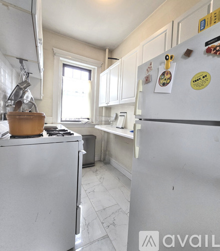 A kitchen with a white fridge and a white stove.