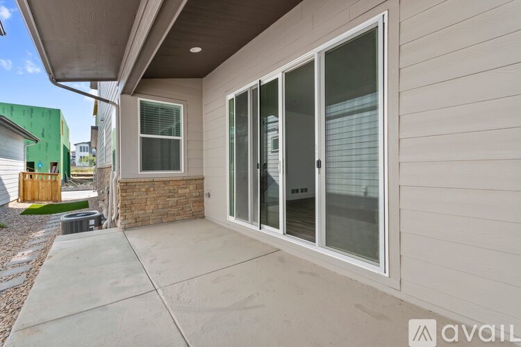 A house with a patio and sliding glass doors.