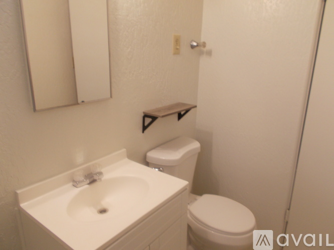A white sink and toilet in a small bathroom.