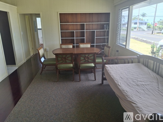 A room with a table and chairs in it.
