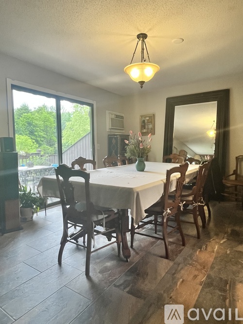 A dining room with a table set for four.