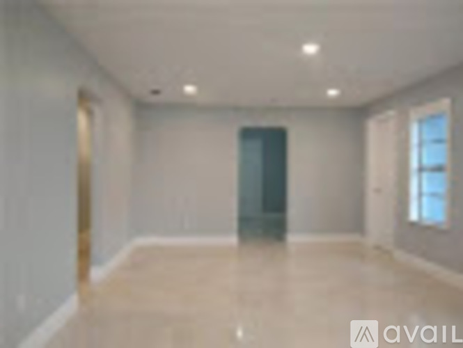 A spacious room with a door and a window.