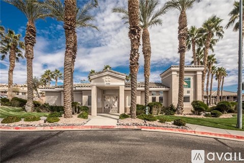 A house with palm trees in front of it.