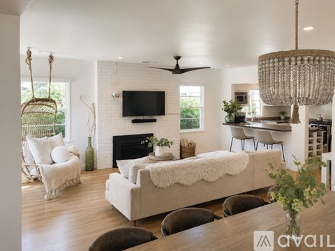 A living room with a white couch and a fireplace.