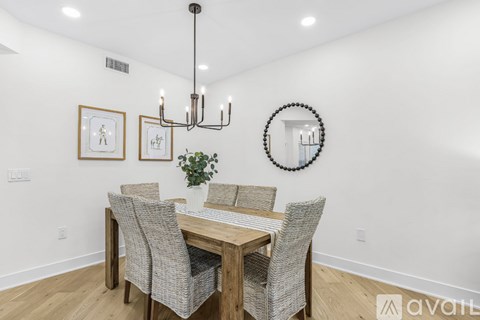 A dining room with a wooden table and chairs.