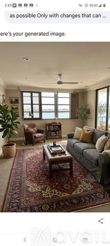 A living room with a grey sofa, a coffee table, and a rug.