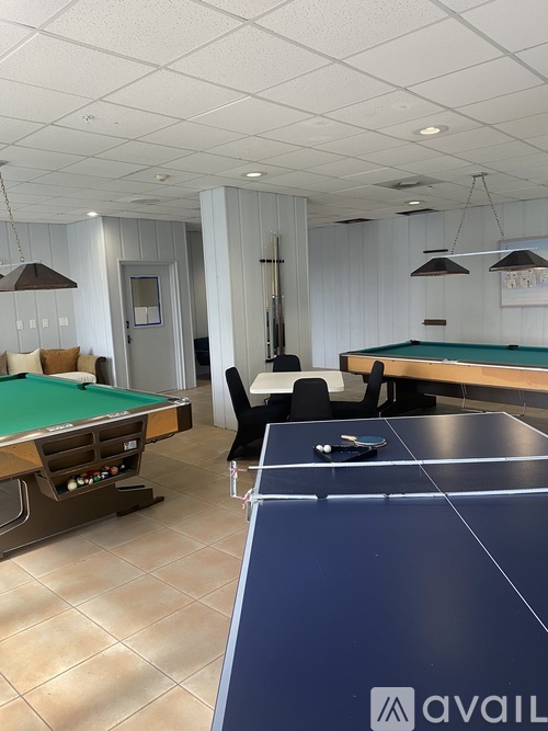 A room with a pool table and a billiard table.