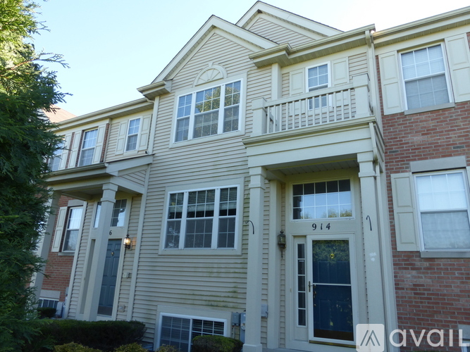 A two-story house with a balcony on the second floor.