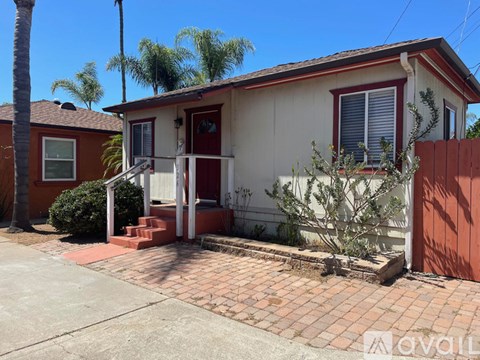 A house with a red door and a white porch.