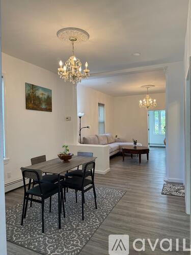 A dining room with a wooden table and chairs.