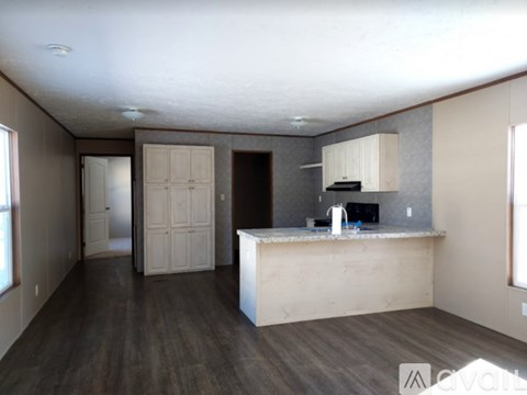 A kitchen area with a counter and cabinets is available for rent.