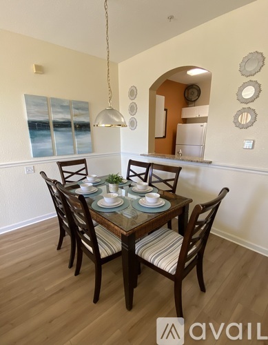 A dining room with a table set for four.