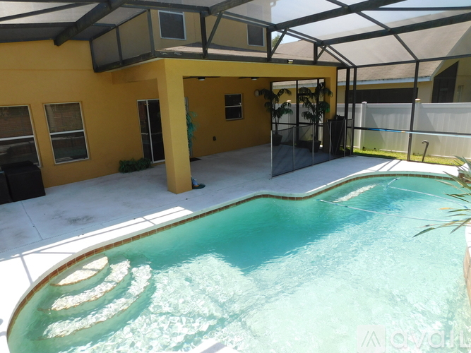 A small pool in a yellow house.