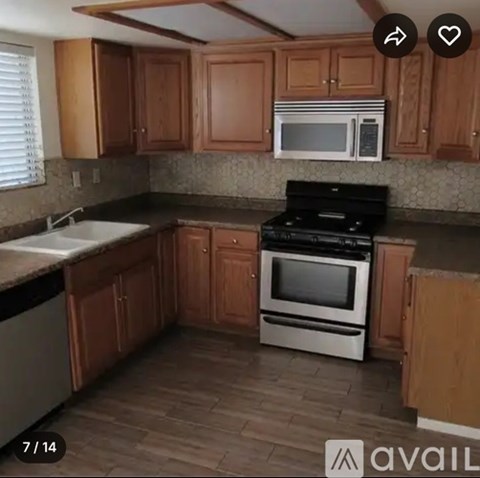 A kitchen with wooden cabinets and a black stove top oven.
