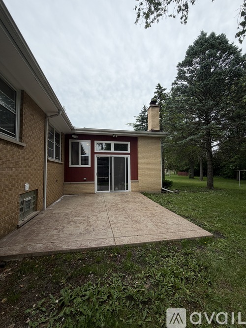 A house with a red door and a brick exterior.