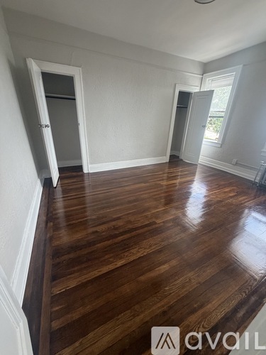 A room with wooden floors and white walls.
