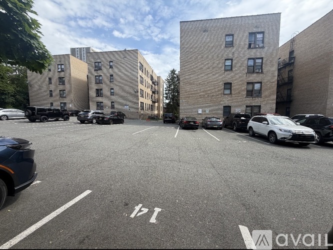 A parking lot with cars and buildings in the background.