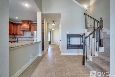 A spacious hallway with a staircase leading to the second floor.