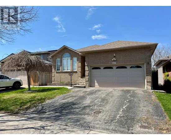 A house with a white garage door is for sale in Brockville.