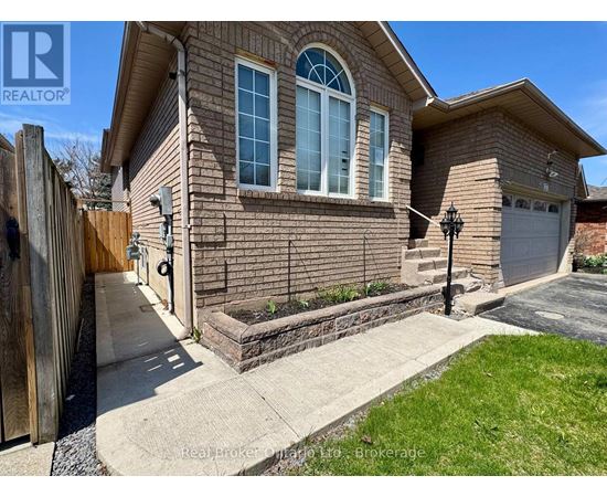 A house with a brown brick exterior and a white garage door.